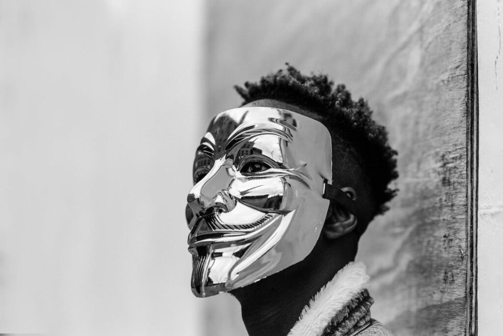 Black activist wearing a Vendetta mask.